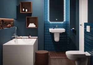 baderom med mørkeblå veggfliser og hvit vask, badekar og toalett